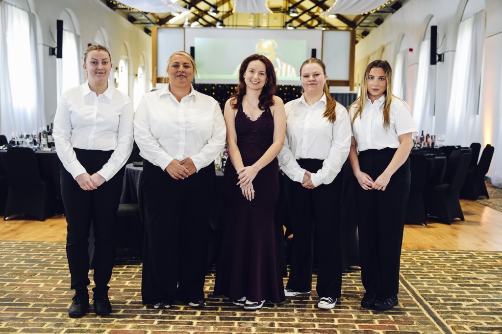 staff in white shirts and black trousers in a professional set up