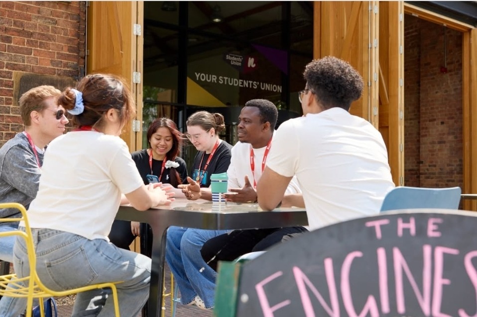 students sat outside on high table